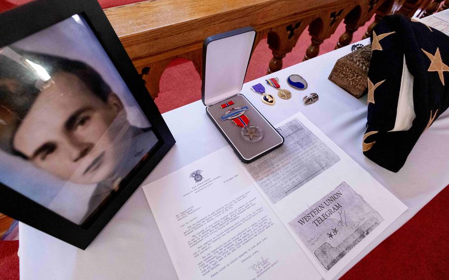 A photo, medals, a telegram and other memorabilia of Martin’s service are placed on a table.