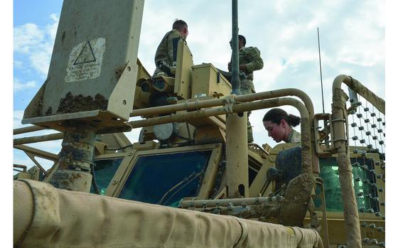 Qayara Airfield West, Iraq, March 17, 2017:  Pfc. Alexandria Campbell helps Sgt. Brandon Bush and Pfc. Shayne Jensen install a .50-caliber machine gun on the Common Remotely Operated Weapon Station atop a mine-resistant vehicle on Qayara Airfield West. In December 2015 then-Defense Secretary Ash Carter announced a decision to open all military jobs to women. Plans for this were finalized for all services in March 2016, right in time for Women's History Month. 

Read Chad Garland's 2017 article looking at the role of women in the military a year after the decision here.
https://www.stripes.com/female-troops-in-iraq-focus-on-the-job-not-our-gender-1.459794

META TAGS: Iraq; Wars on Terror; B Company, 37th Brigade Engineer Battalion, 2nd Brigade Combat Team, 82nd Airborne Division; U.S. Army; women in the military; Women's History Month;