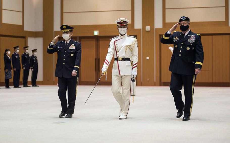 Army Gen. James Dickinson, far right, who oversees U.S. Space Command, reviews Japanese troops during a visit to the Ministry of Defense in Tokyo, Friday, May 21, 2021. 