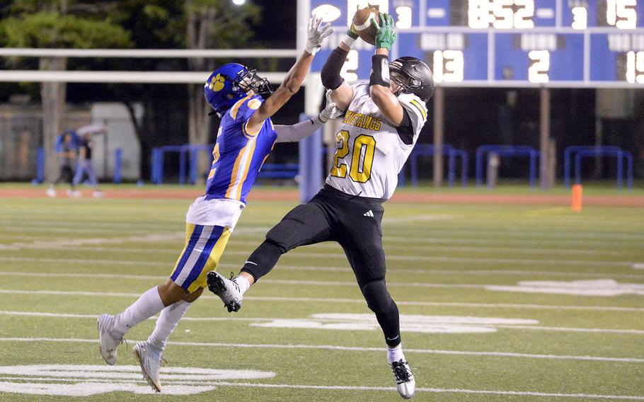 American School In Japan’s Noa Grasse snags one of five Mustangs interceptions against Yokota’s Royce Canta.