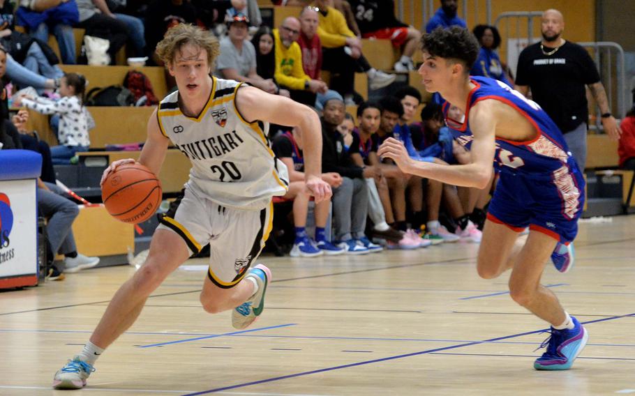 Stuttgart’s Jacob Schudel drives against Ramstein’s Dominic Brooks in the boys Division I final at the DODEA-Europe basketball championships in Wiesbaden, Germany, Feb. 17, 2024. Stuttgart won the game 47-36.