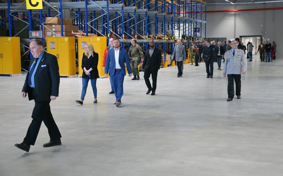 Guests explore the Training Support Center warehouse at Grafenwoehr Training Area, Germany, March 22, 2023. The new center combines all training aids, devices, simulators, classrooms and visual information in one building. 
