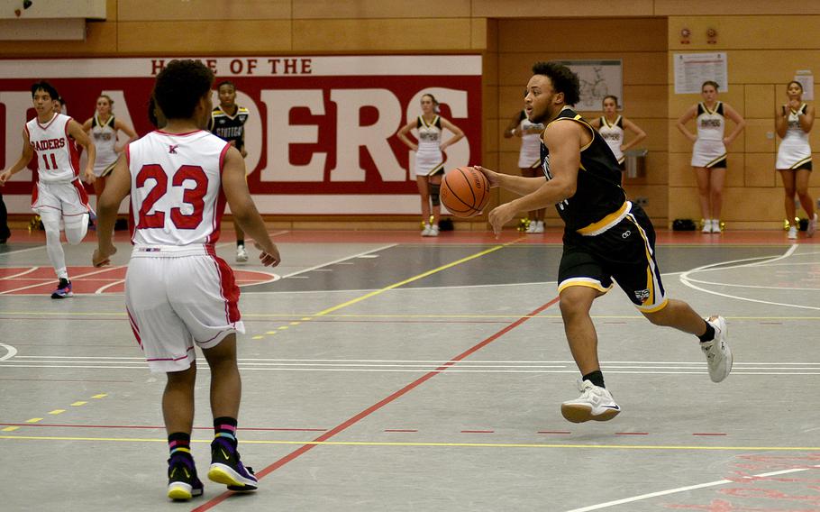 Stuttgart's Trenton Jackson, right, prepares to drive to the basket as Kaiserslaiutern's Tyriq Etan backpeddles during Friday's game at Kaiserslautern High School in Kaiserslautern, Germany. The Panthers won, 67-47.