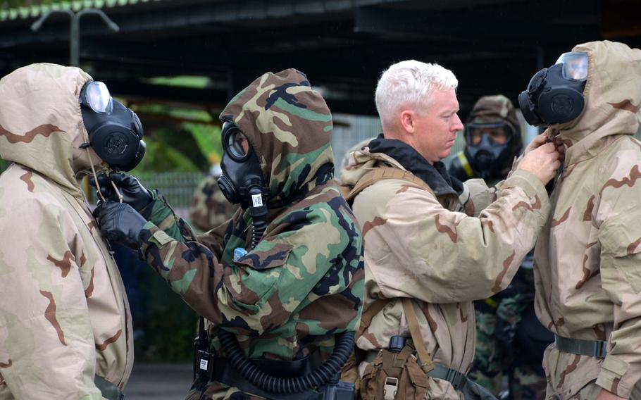 U.S. Marines and Thai soldiers adjust one another's protective gear during a Cobra Gold evacuation drill in Rayong, Thailand, March 3, 2024.