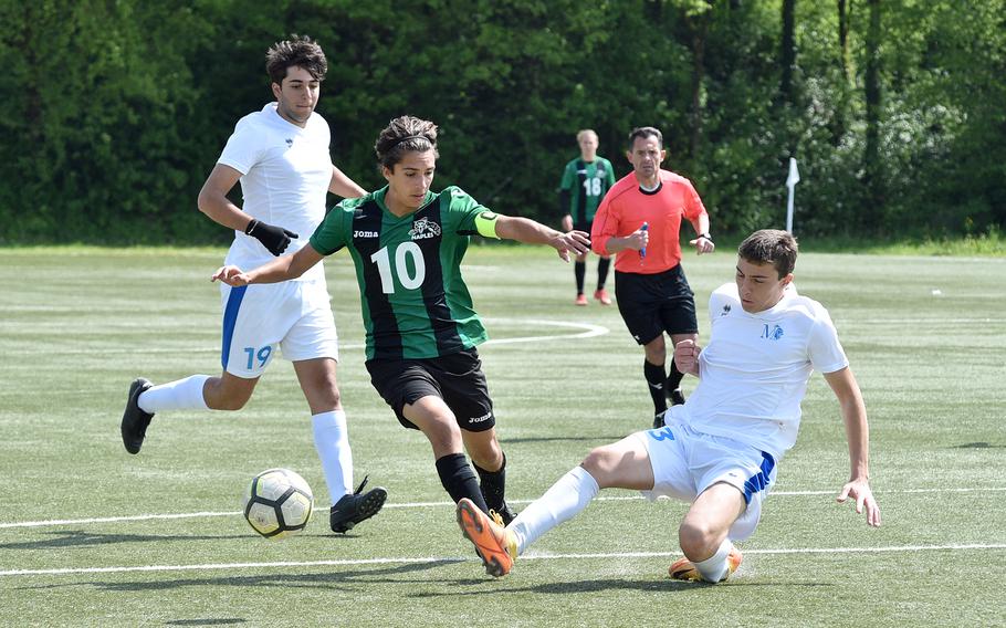 Marymount's Adriano Paoluzi tackles the ball away from Naples midfielder Thomas Albright in the 18-yard box during a Division II semifinal at the DODEA European soccer championships on May 17, 2023, at VfR Baumholder's stadium in Baumholder, Germany.