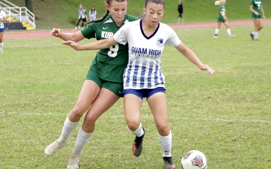 Kubasaki's Hailey Brooke and Guam High's Kailee Guerrero tussle for the ball during Wednesday's Divison I Far East girls soccer final.