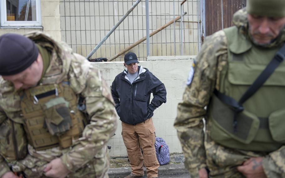 Mike Postupak, an American volunteer for Task Force Yankee Ukraine, a group that provides humanitarian aid, observes as Ukrainian soldiers practice first aid at a training site outside Kyiv, on Oct. 27, 2022. Postupak is chief of operations in Kyiv and eastern Ukraine for the group, which mostly consists of military veterans and offers medical training.