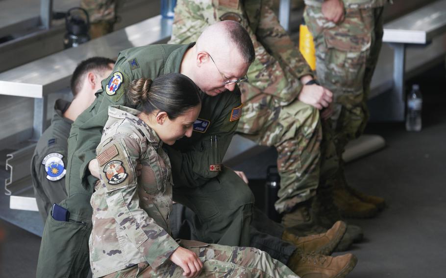An overheated airman loses her footing during the 18th Wing change-of-command ceremony at Kadena Air Base, Okinawa, Thursday, July 6, 2023.