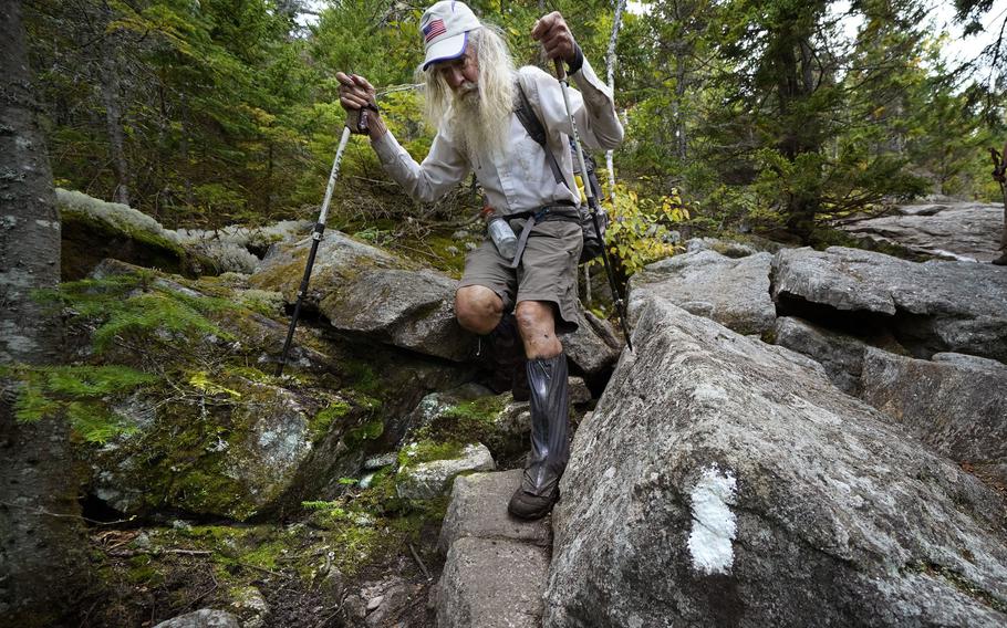 M.J. Eberhart, 83, carefully makes his way through large rocks while descending Mount Hayes on the Appalachian Trail, Sunday, Sept. 12, 2021, in Gorham, N.H. 