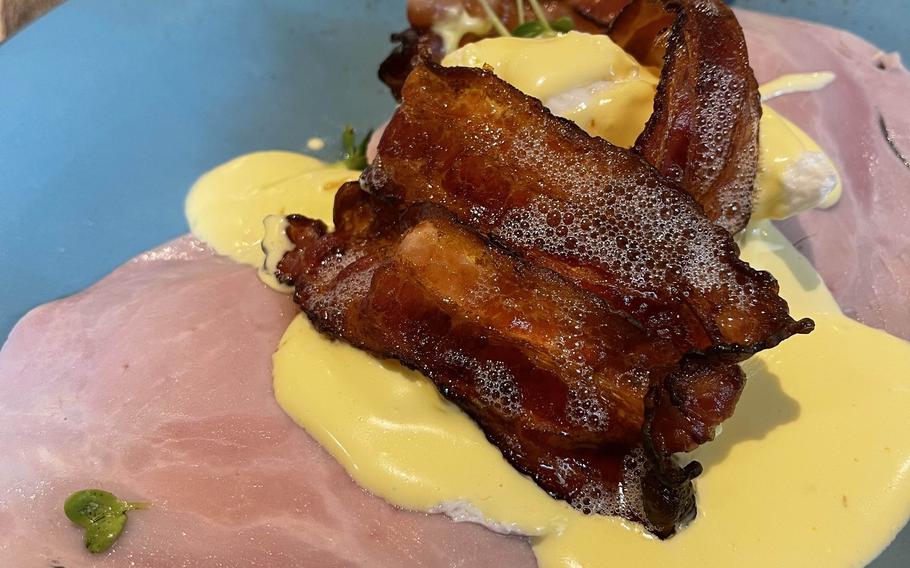 The eggs benedict comes with cooked ham and crispy bacon at The Victorian House on July 2, 2021 in Munich, Germany. 