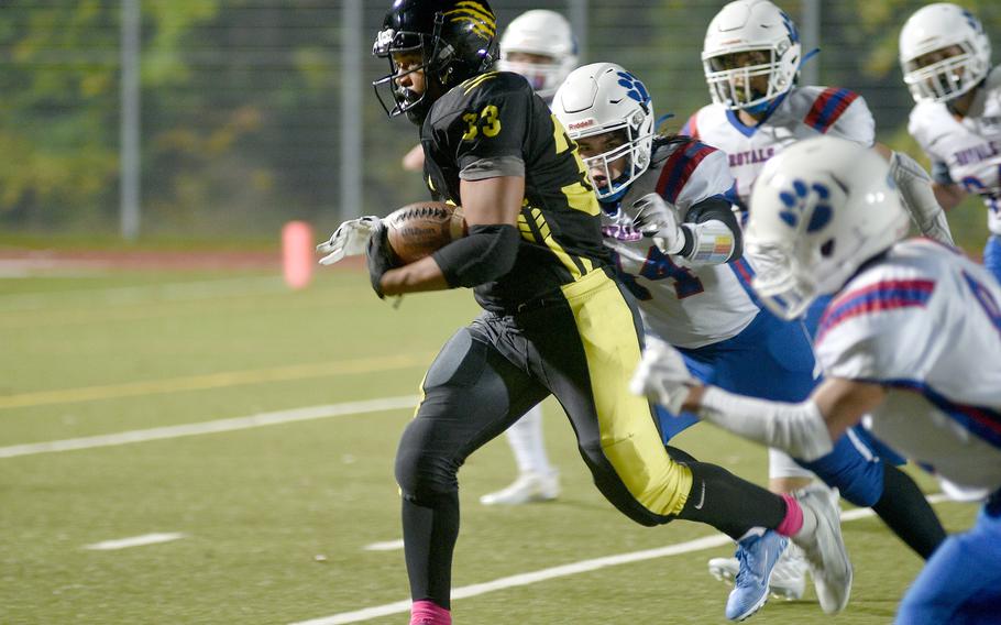 Stuttgart’s Trenton Jackson outruns a host of Ramstein defenders during a DODEA-Europe Division I semifinal Friday evening in Stuttgart, Germany.