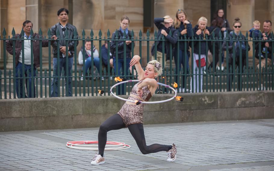 A female street perfomer does a dangerous stunt with fire and a hula hoop at a recent Edinburgh Fringe Festival in Scotland.