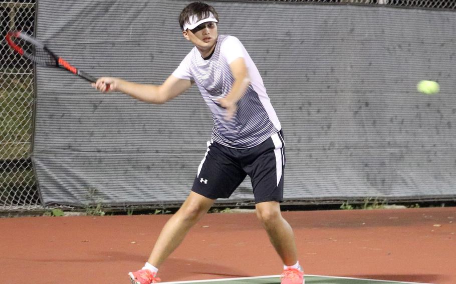 Zama’s Liam Hunter readies to hit a forehand return against Yokota’s Ethan Sessions during Friday’s Japan tennis matches. Hunter won 8-6.