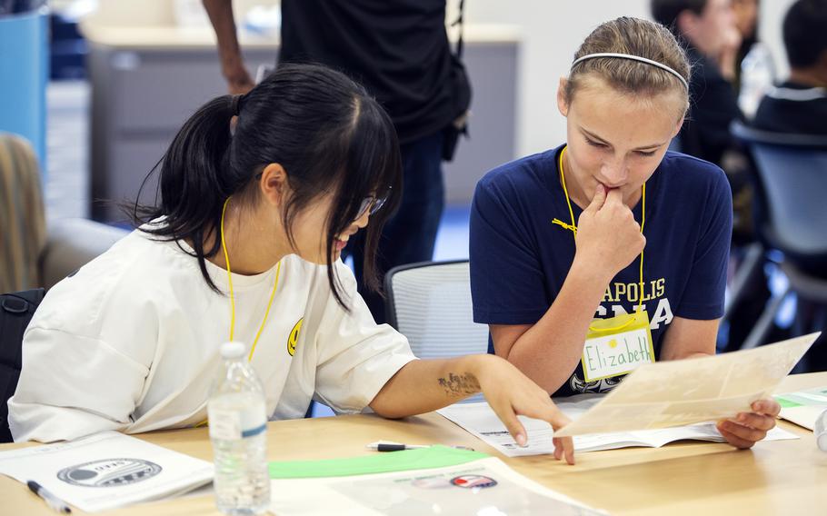 Elizabeth Shoop works with Nagi Takemoto during the Student Educational Exchange and Dialogue camp at Matthew C. Perry High School, Marine Corps Air Station Iwakuni, Japan, Sept. 23, 2023. 