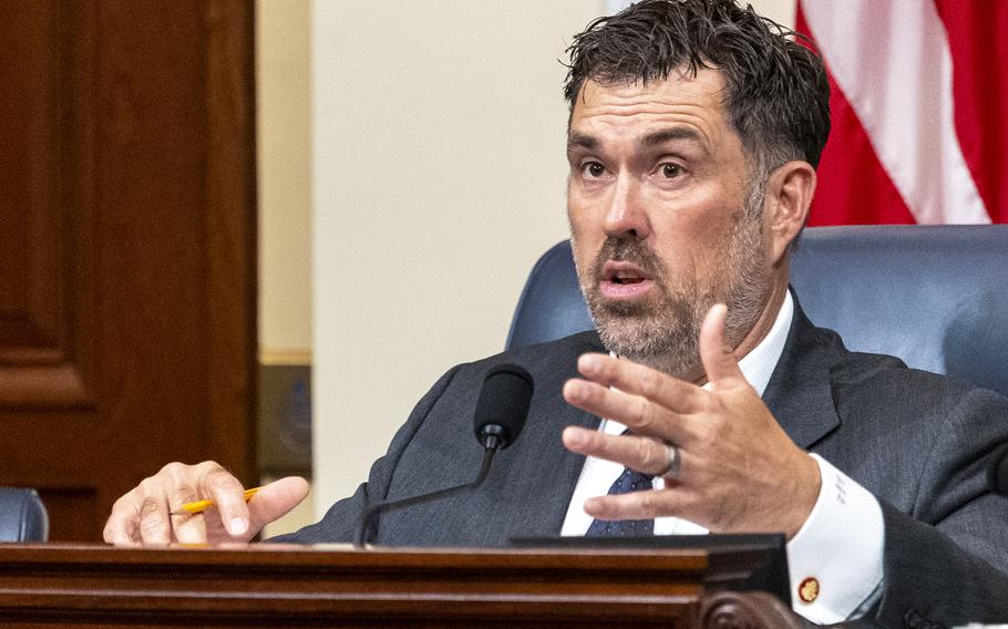 Morgan Luttrell seated and speaking at a hearing.