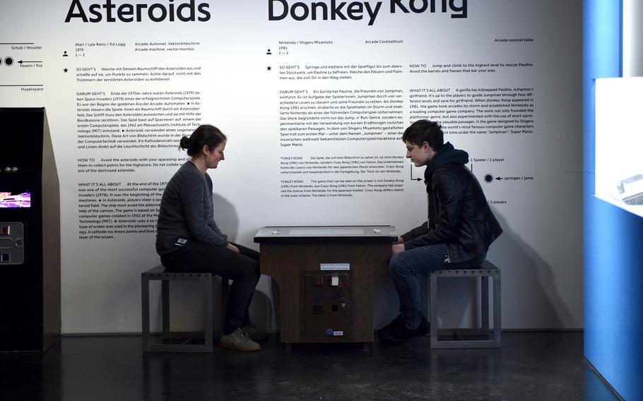 Visitors play the Crazy Kong game from Falcon, which had acquired the license for the original Donkey Kong arcade game from Nintendo in 1981, at the “zkm_gameplay. the next level” exhibition in the Zentrum fuer Kunst und Medien Karlsruhe on Nov. 26, 2022, in Karlsruhe, Germany. The arcade table is from Nintendo.