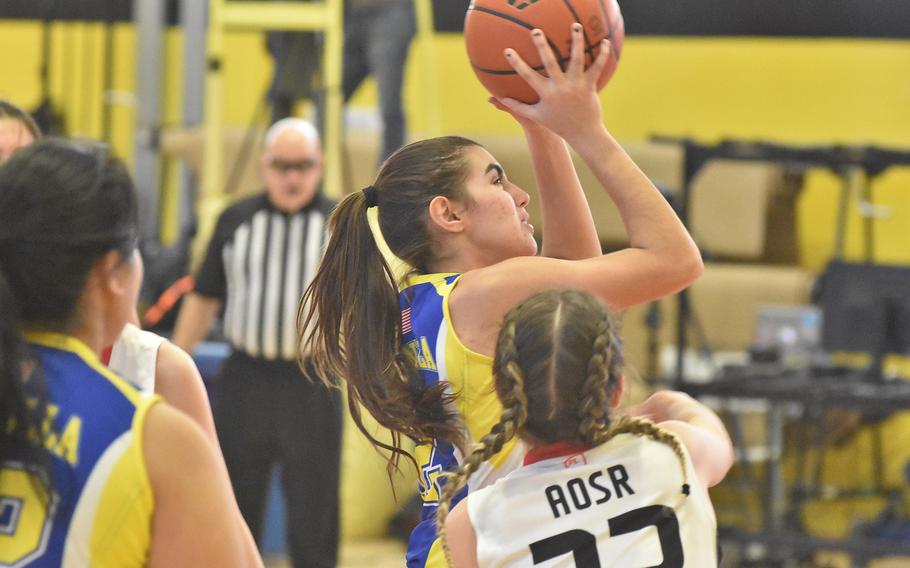 Sigonella's Fabiola Mercardo-Rodriguez prepares to shoot in the midst of a host of American Oversas School of Rome defenders in the championship game of the DODEA-Europe Division II title game Saturday, March 5, 2022.