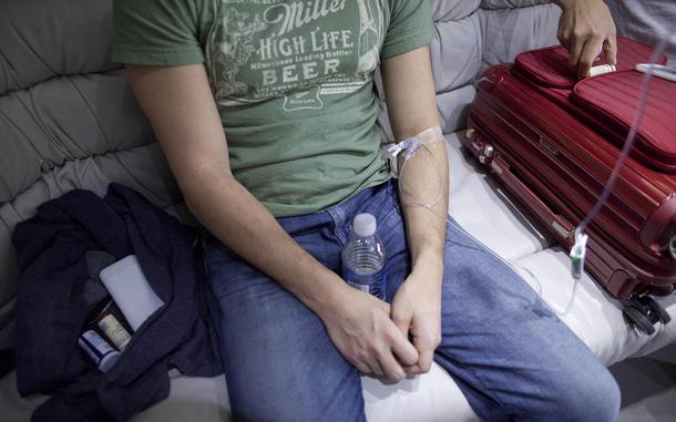 A patient is hooked up to an IV for a hangover treatment.