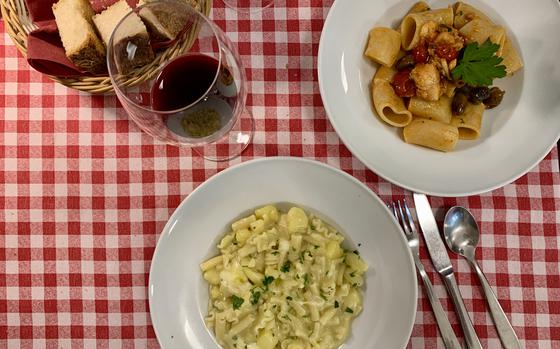 Pastificio Cuomo Traditional Trattoria in Gragnano, Italy, offers a variety of pasta made onsite. Featured here are traditional pasta con patate, or pasta with potato, bottom, and paccheri alla puttanesca di bacala, a tubelike pasta with cod, tomato, capers, olives and peppers.