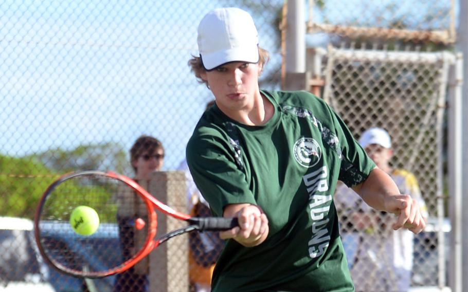 Kubasaki's Owen Ruksc hits a forehand return against Kadena's Maddux Fixk during Tuesday's Okinawa tennis matches. Ruksc won 6-0 and the Dragons boys beat the Panthers 4-2.