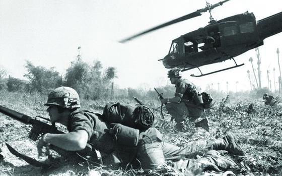 Major Bruce Crandall's UH-1D helicopter climbs skyward after discharging a load of infantrymen on a search and destroy mission, Ia Drang.