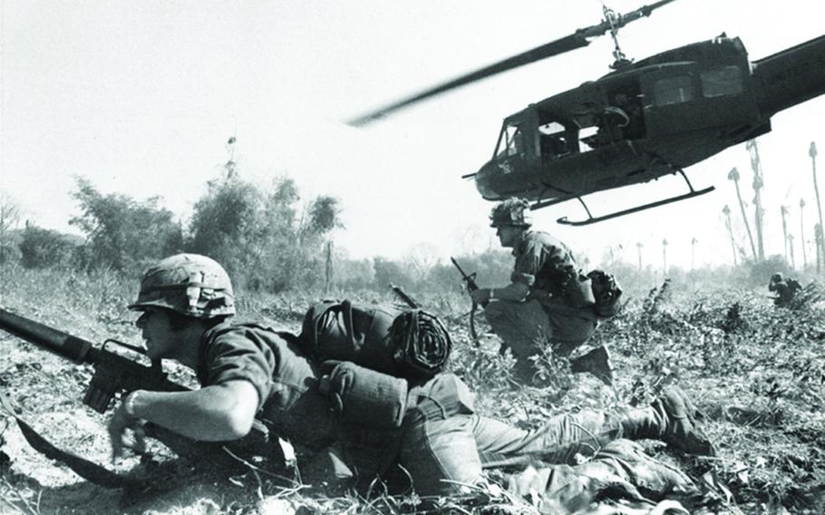 Major Bruce Crandall’s UH-1D helicopter climbs skyward after discharging a load of infantrymen on a search and destroy mission in Ia Drang.