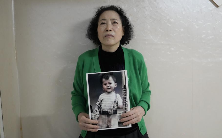 Choi Young-ja holds a photo of her son.