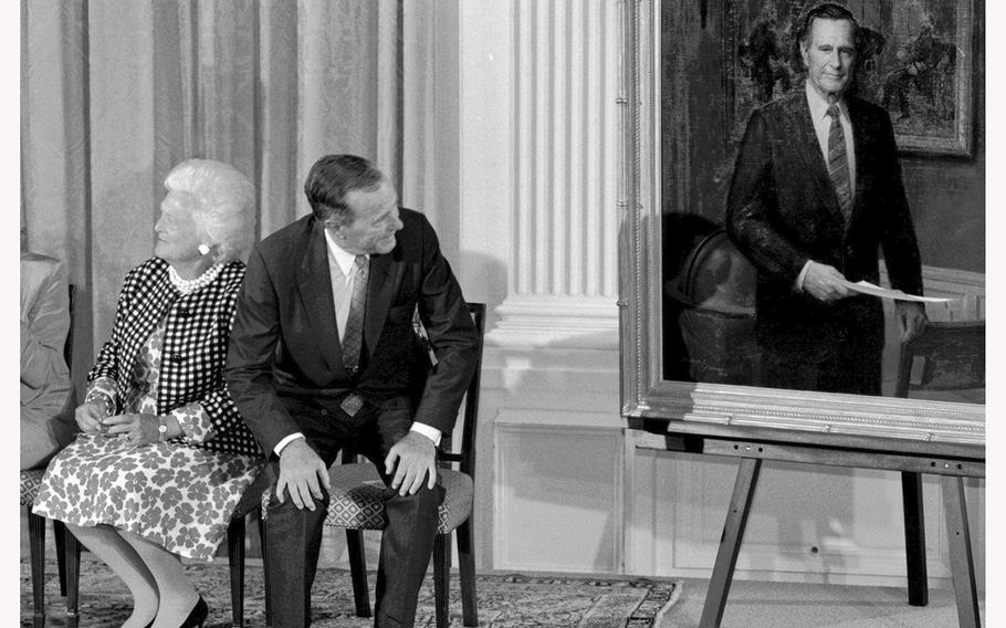 Former president George H.W. Bush takes a look at his official portrait after a White House unveiling. 