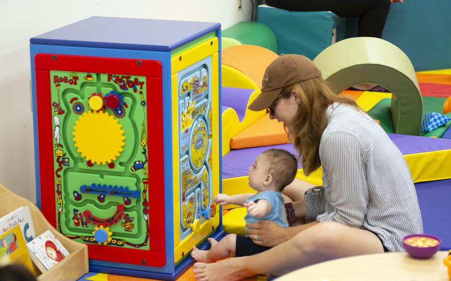 A woman playing with her baby.