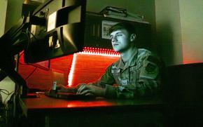 Airman Tyler Shipley, a cyber systems operations specialist with the 121st Air Refueling Wing, works on a computer at Rickenbacker Air National Guard Base in Columbus, Ohio, on April 7, 2024. 
