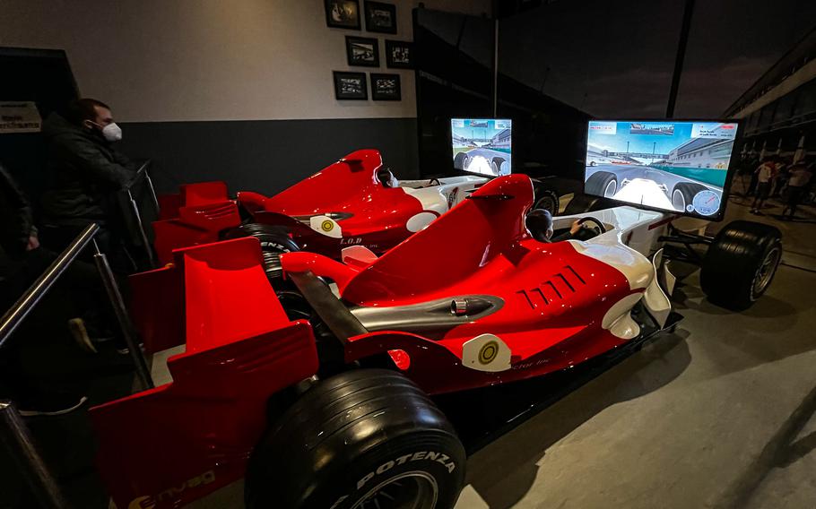 Visitors take a virtual ride over the Nuerburgring Grand Prix track in full-sized Formula 1 simulators at Ringwerk Experience in Nuerburg, Germany, Jan. 15, 2022. 