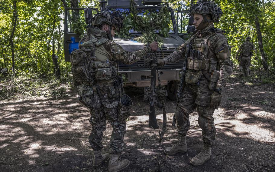 Ukrainian soldiers, who go by their call signs Brandy, left, and Toker, of the 47th Separate Mechanized Brigade. 