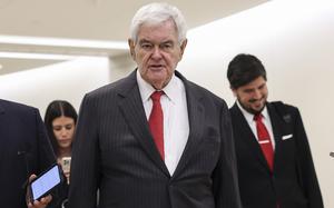 Newt Gingrich in a pinstriped suit and red tie.