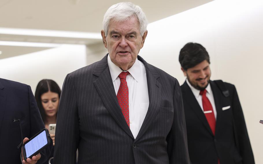 Newt Gingrich in a pinstriped suit and red tie.