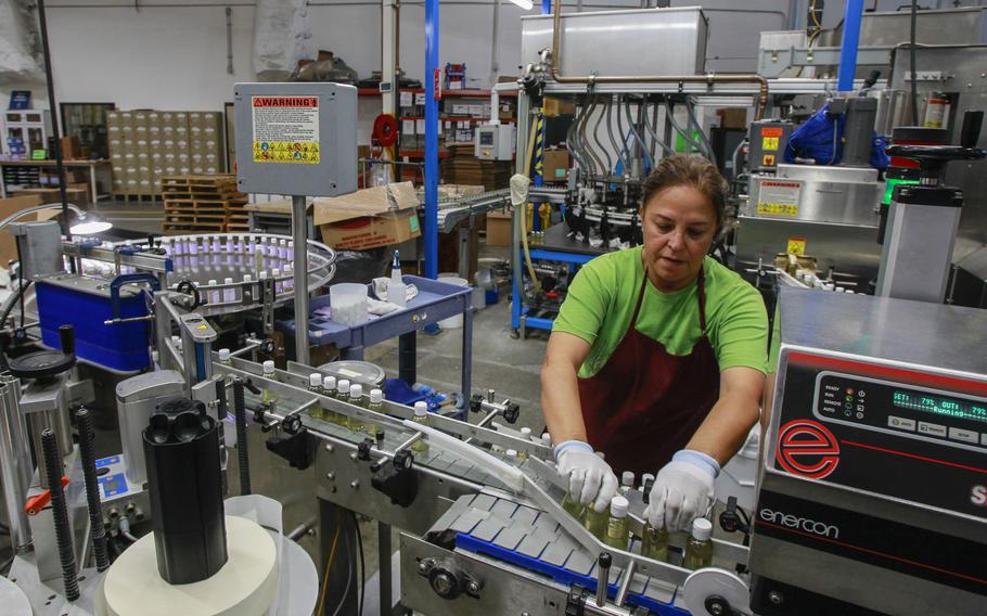 Leticia Maldonado works in the packing area at the factory for the Dr. Bronner’s company on October 24, 2019, in Vista, Calif.