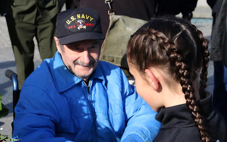 World War II veteran Marovelli meets a young admirer after the Veterans Day ceremony at the National World War II Memorial in Washington, November 11, 2023.