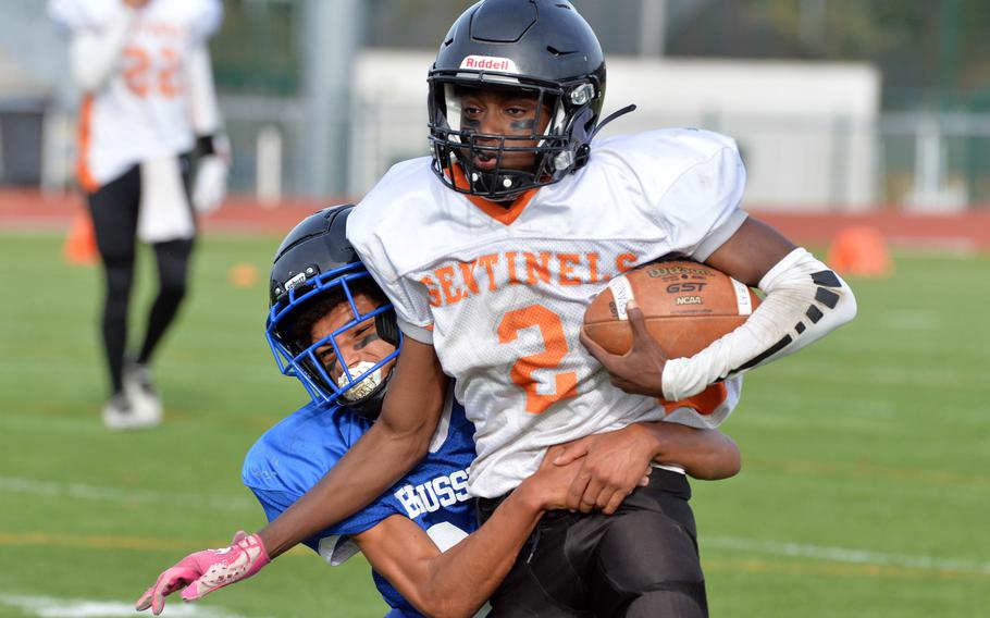 Spangdahlem’s Markario Drummond gains some yards despite the defense of Brussels’ Charles DeMarkus in the DODEA-Europe Division III football final in Kaiserslautern, Germany, Oct. 29, 2022. Brussels beat Spangdahlem 64-48.