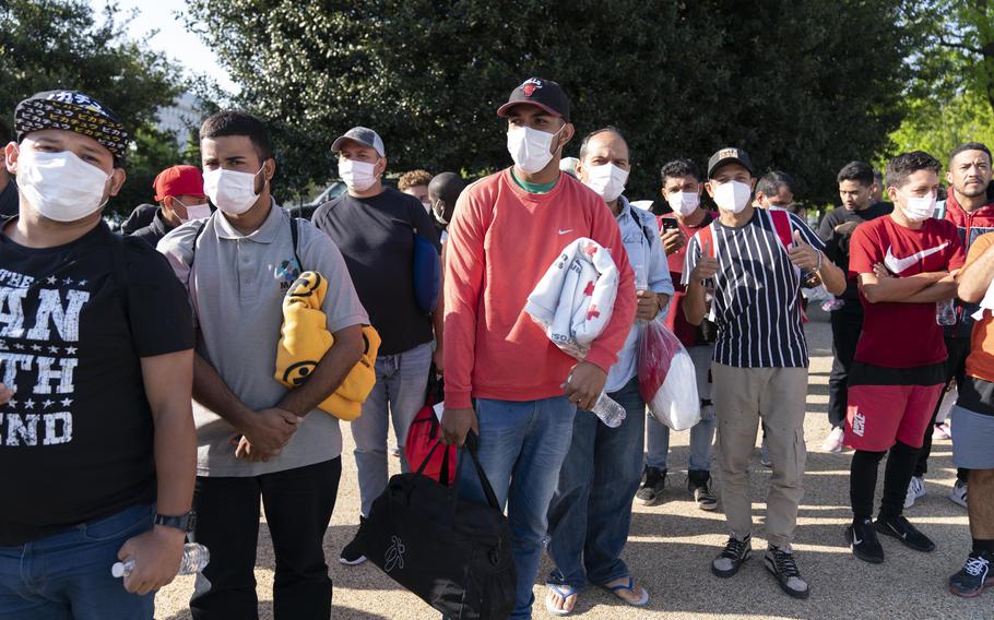 Migrants hold Red Cross blankets after arriving at Union Station near the U.S. Capitol from Texas on buses, April 27, 2022, in Washington. The Pentagon has rejected a request from the District of Columbia seeking National Guard assistance for the thousands of migrants being bused to the city from two southern states.