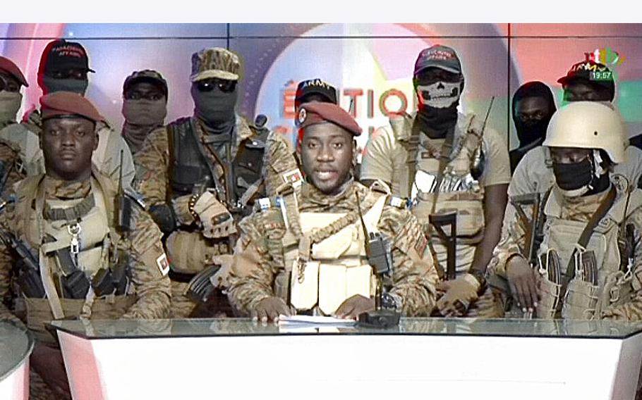 A video screen grab shows coup spokesman Capt. Kiswendsida Farouk Azaria Sorgho reading a statement in a studio in Ougadougou, Burkina Faso, on Friday evening, Sept. 30, 2022. 