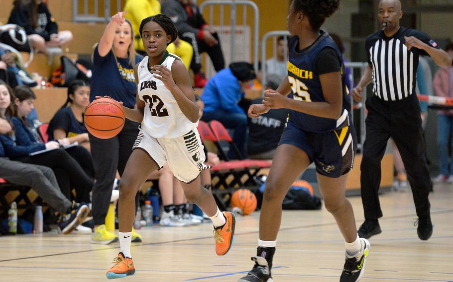AFNORTH’s Makayla McNiell-Mark drives the ball up the court against Ansbach’s Elizabeth Agudzi-Addo in the girls Division III final at the DODEA-Europe basketball championships in Wiesbaden, Germany, Feb. 17, 2024. AFNORTH took the title with a 34-23 win.