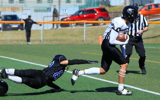 Zama's Keahnu Araki makes for the end zone for one of his two touchdown catches ahead of Osan's Anthony Waight-Forrester.