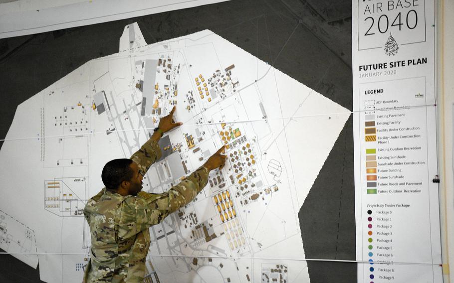 Maj. Samuel Richardson, construction management chief at the 9th Air Force program management office, points to the location of two dining facilities — one new and one old — on a future site plan map of Al Udeid Air Base, Qatar, in 2022. The U.S. has reportedly reached a deal with Qatar to extend its military presence at Al Udeid for another 10 years.