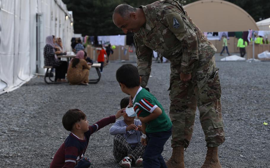 U.S Air Force Col. Soleiman Rahel, Task Force Liberty governor, gives children candy in Liberty Village, Joint Base McGuire-Dix-Lakehurst, New Jersey, Oct. 7, 2021.