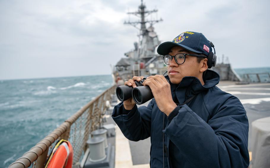 Seaman Xi Chan stands lookout on the USS Barry's flight deck as the guided-missile destroyer passes through the Taiwan Strait in April 2020. 