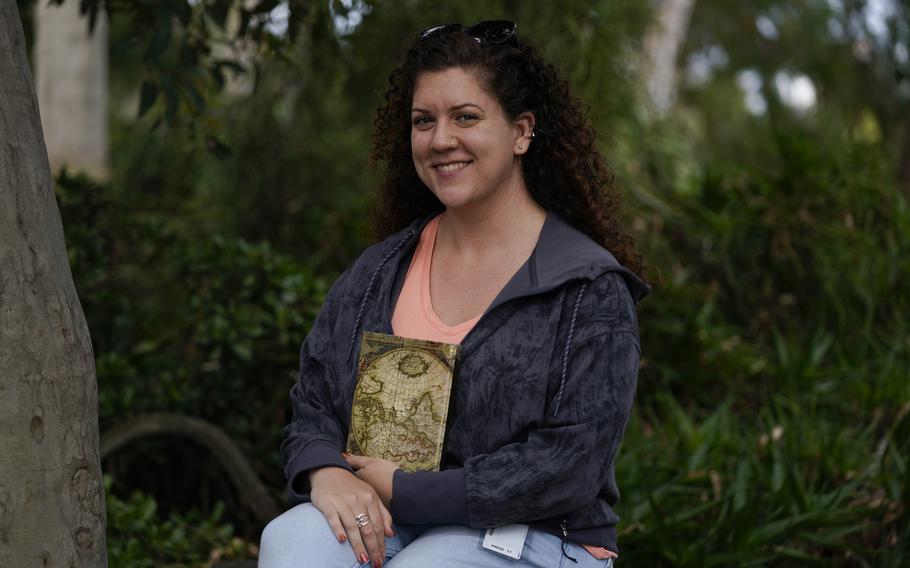 Topaz Cooks holds a journal as she poses for a portrait Tuesday, May 16, 2023, in San Diego. As the number of people who die in mass killings in the U.S. continues to rise, thousands more are left to handle the trauma of losing someone they love.