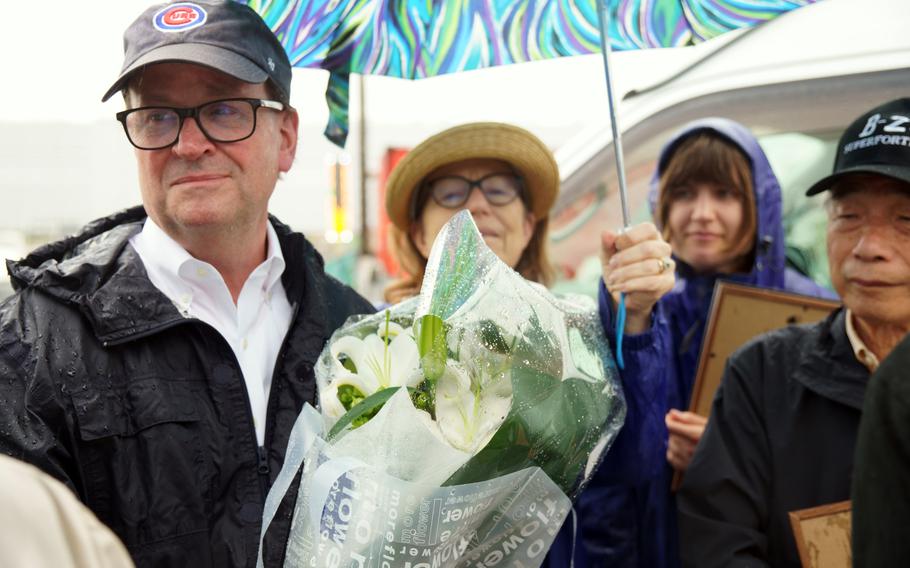 Bill O’Connor, nephew of U.S. Army Air Forces 2nd Lt. Edward O'Connor, holds flowers for a U.S. B-29 Superfortress crew while visiting Tokyo Bay on June 9, 2023. His uncle died when the bomber went down in the bay on March 10, 1945.