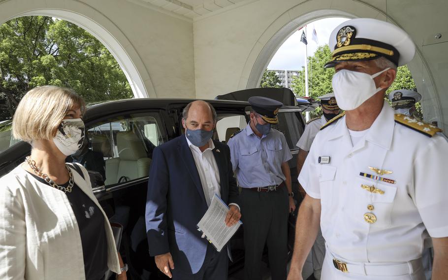 The U.S. 7th Fleet commander, Vice. Adm. Karl Thomas, greets the United Kingdom’s Secretary of State for Defence Ben Wallace and Ambassador to Japan Julia Longbottom at Yokosuka Naval Base, Japan, Wednesday, July 21, 2021. 