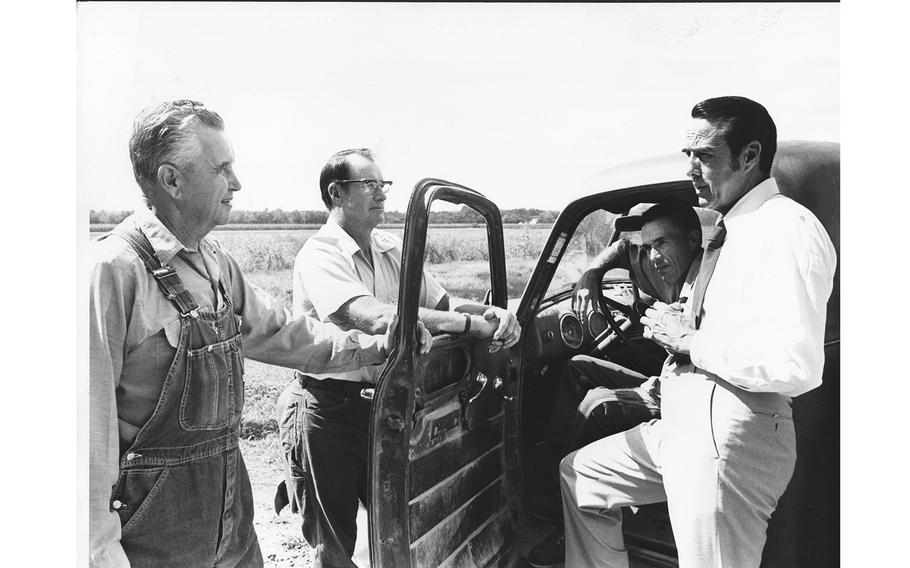 Bob Dole talks with Kansas farmers in 1974.