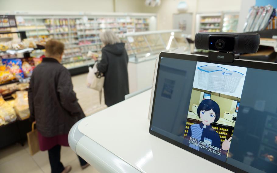 Customers shop at Green Lawson, the first convenience store in Japan to be staffed by avatars, Dec. 5, 2022.