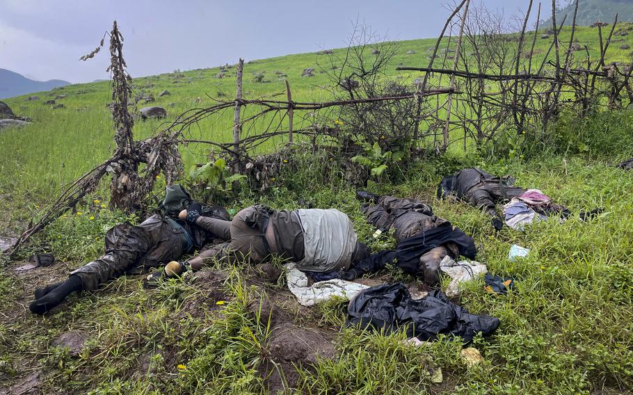 The dead bodies of unidentified people wearing military uniforms lie on the ground near the village of Chenna Teklehaymanot, in the Amhara region of northern Ethiopia on Thursday, Sept. 9, 2021.